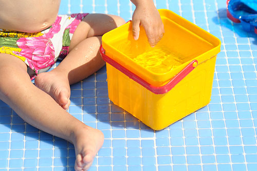 baby-playing-with-a-bucket